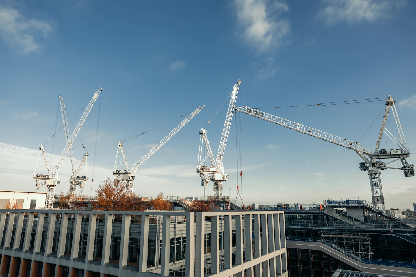 Tower cranes above a commercial building under construction
