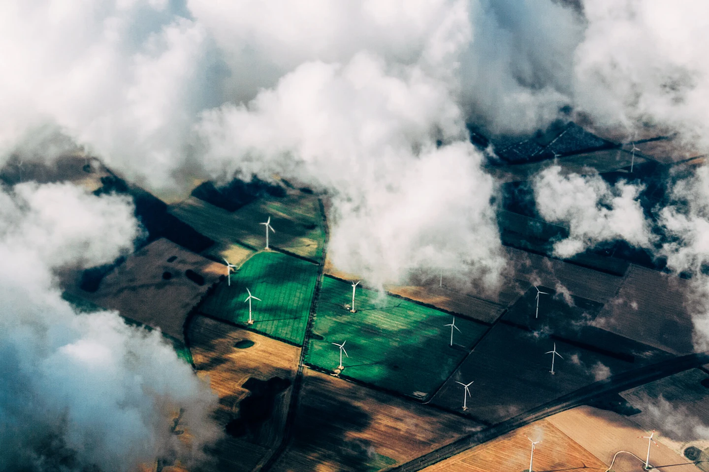 Commercial wind turbines across agricultural fields